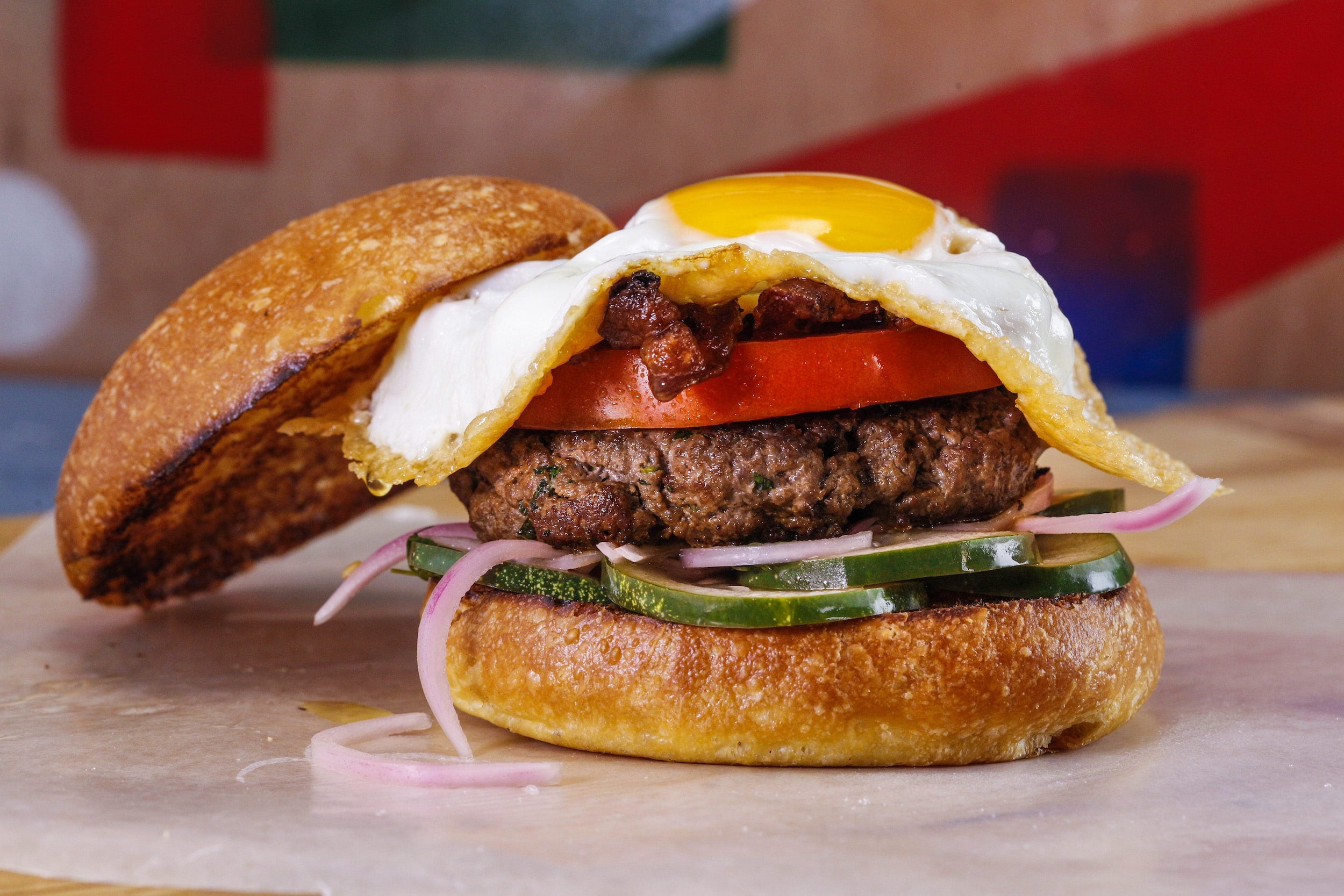 Rachael's Garlicky Burgers with Bacon, Beefsteak Tomato and Parm Frico Eggs and Quick Pickles
