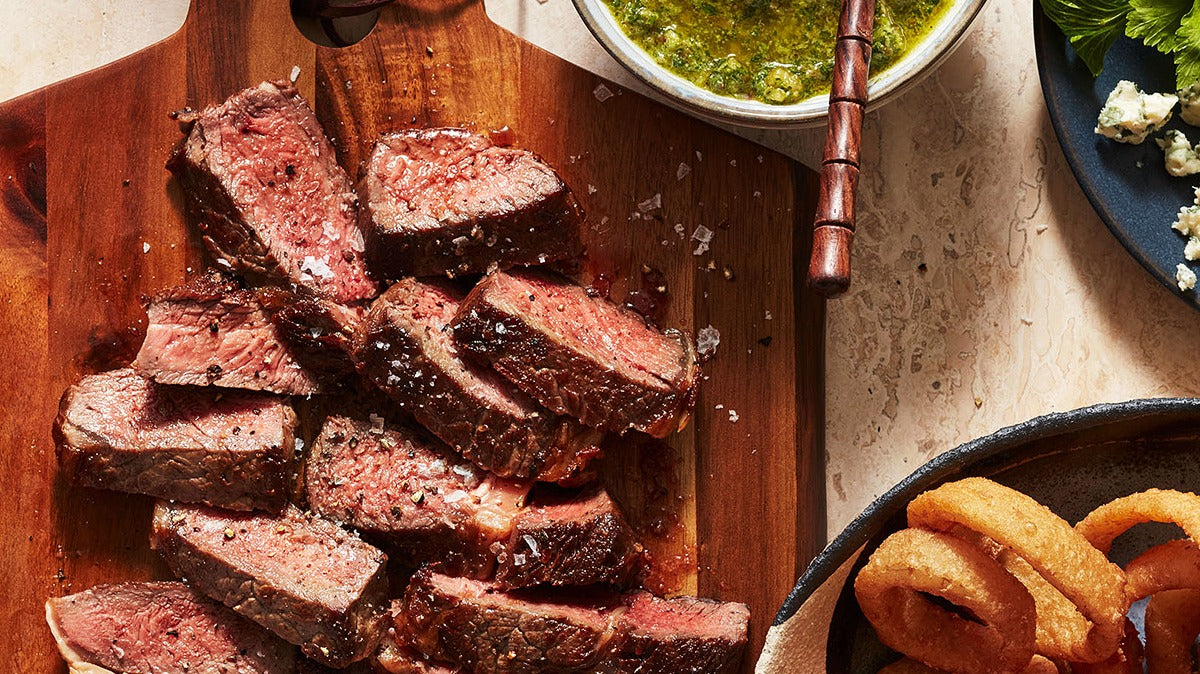 Sliced Rib Eye Steaks with Watercress-Walnut Pesto & Blue Cheese Crumbles