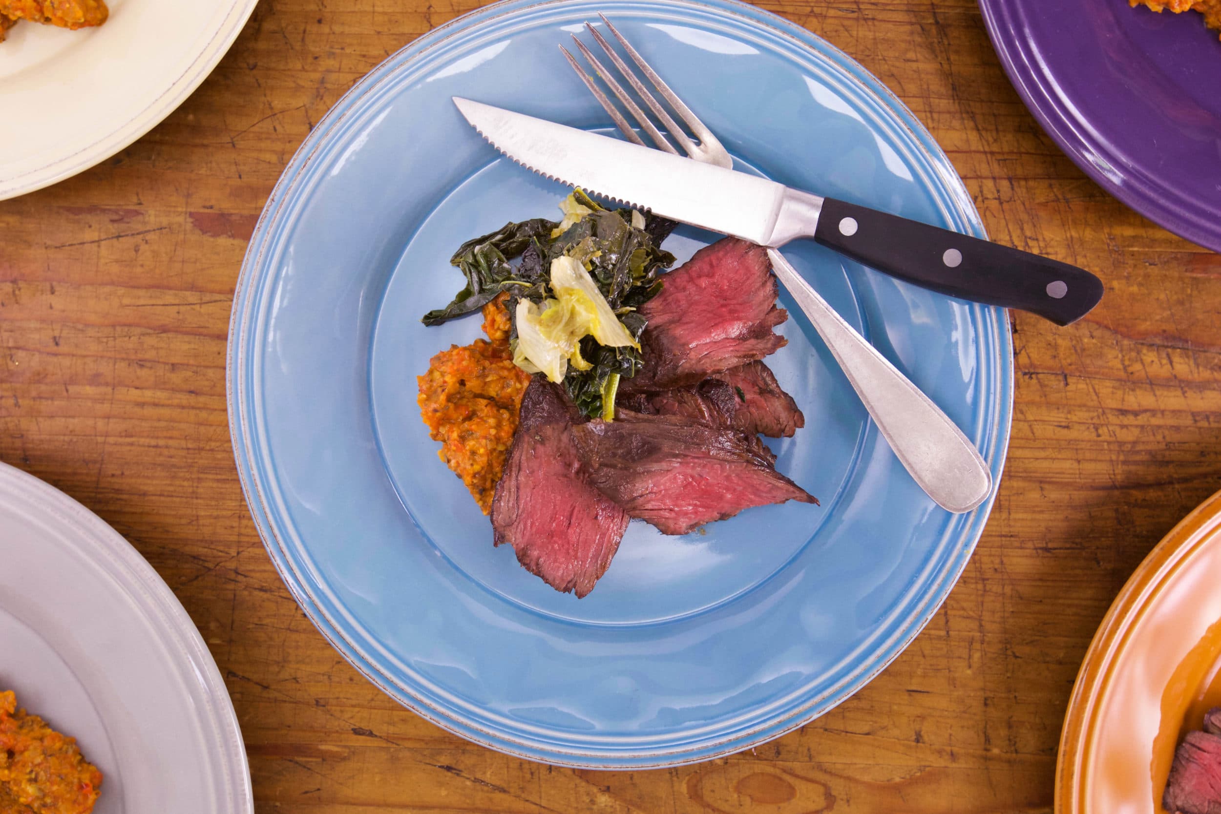 Steak with Three-Pepper Bomba and Braised Greens
