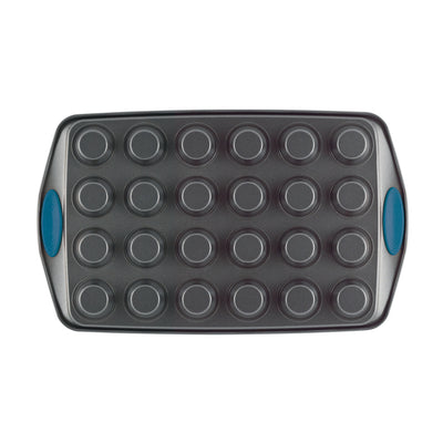 A 24-cup nonstick mini muffin pan with blue silicone handles.