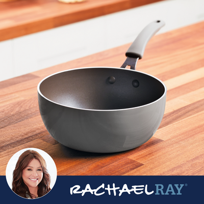 A gray saucepan with a black handle on a wooden countertop.