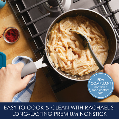 Person stirring pasta in a nonstick pot on a stovetop.