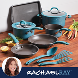 Blue cookware set with pots, pans, utensils, and vegetables on a countertop.