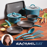 Blue cookware set with pots, pans, utensils, and vegetables on a countertop.