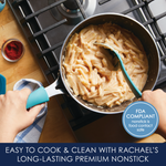 Person stirring pasta in a saucepan on a stovetop.