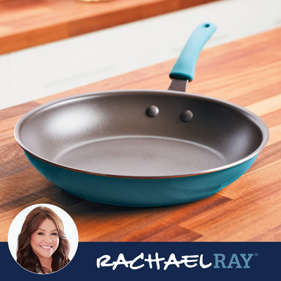 Blue frying pan on a wooden counter with Rachael Ray branding.