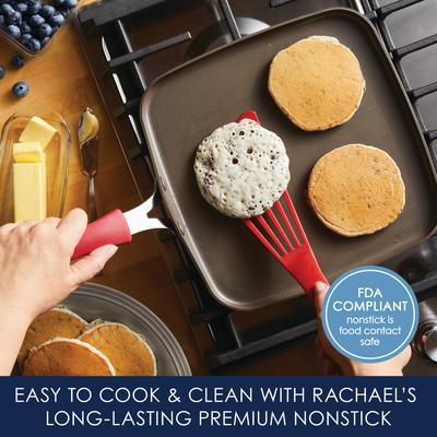 Cooking pancakes on a square nonstick griddle with a red spatula.