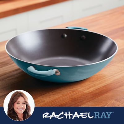 A blue nonstick frying pan on a wooden countertop.