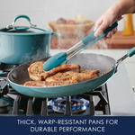 Cooking pork chops in a frying pan on a gas stove.
