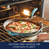 Person placing a pan with food into an oven.