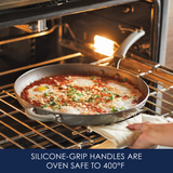 Pan with food in oven, silicone handles visible, text highlights safety feature.