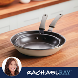 Two stacked frying pans on a wooden counter; Rachael Ray logo in corner.
