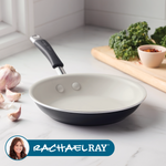 Nonstick frying pan on a kitchen counter with garlic and kale nearby.