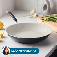 A frying pan on a kitchen counter with green beans and garlic nearby.