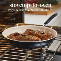 Steak cooking in a pan inside an oven. Oven-safe up to 400°F.