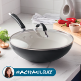 Covered black frying pan on kitchen counter with vegetables nearby.