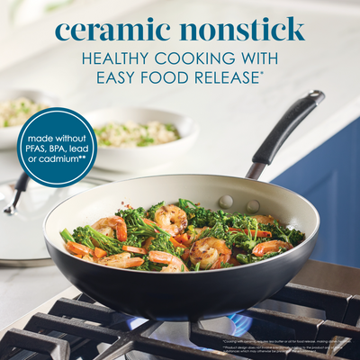 Ceramic nonstick pan on stove with shrimp and broccoli dish cooking.