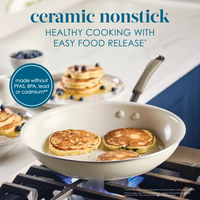 Ceramic nonstick pan with pancakes on a stovetop in a kitchen.