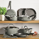 Cookware set with pots, pans, bakeware, and utensils on wooden shelves.