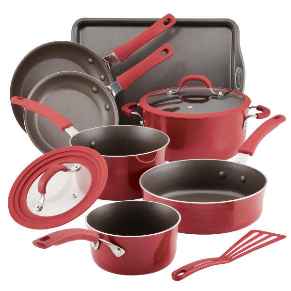 The Cook + Create Nonstick Cookware Set in red includes pots, pans, lids, a baking sheet, and a spatula. Each piece is scratch-resistant and oven-safe for versatile cooking.