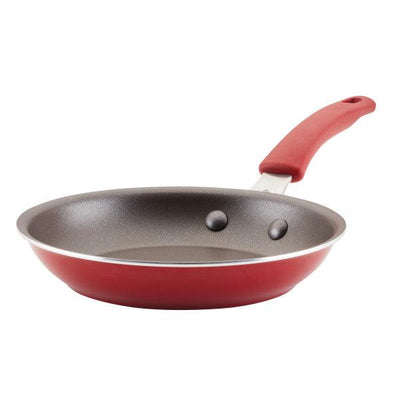 Red frying pan with non-stick coating and a red handle.