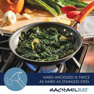 Frying pan with greens cooking on a gas stove, branded Rachael Ray.