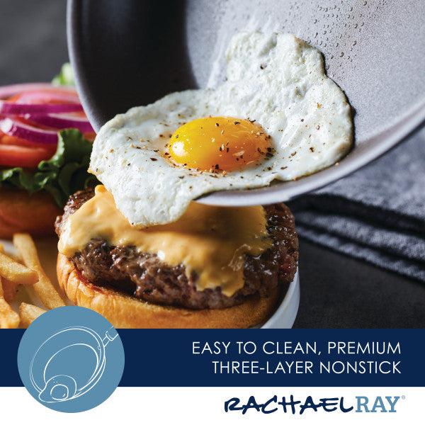 The Cook + Create Nonstick Frying Pan is used to perfectly cook a fried egg that tops a cheeseburger, accompanied by crispy fries on the side.
