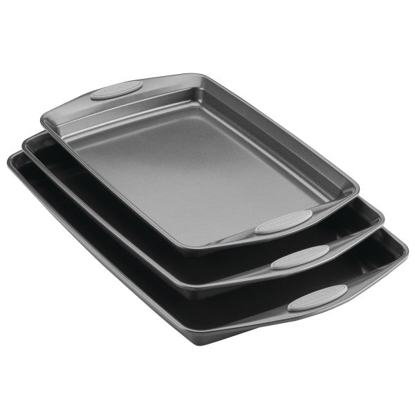 The 3-Piece Nonstick Sheet Pan Set is crafted from durable steel and includes three stacked baking sheets with rubberized grips, all of which are perfectly oven safe.