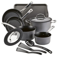 The Cook + Create Hard Anodized Nonstick Cookware Set includes black nonstick pots and pans, tempered glass lids, a spatula, and a baking sheet.