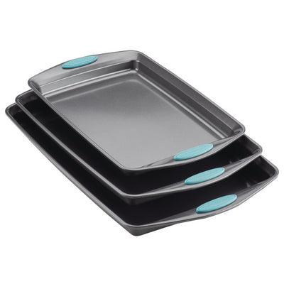 Three stacked baking trays with teal handles.