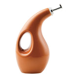 Curved brown ceramic oil dispenser with a handle.