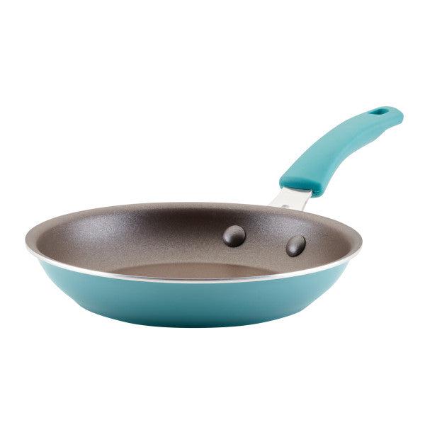 The Cook + Create Nonstick Frying Pan is a high-performance turquoise frying pan made with thicker gauge aluminum, featuring a nonstick coating and a matching handle.