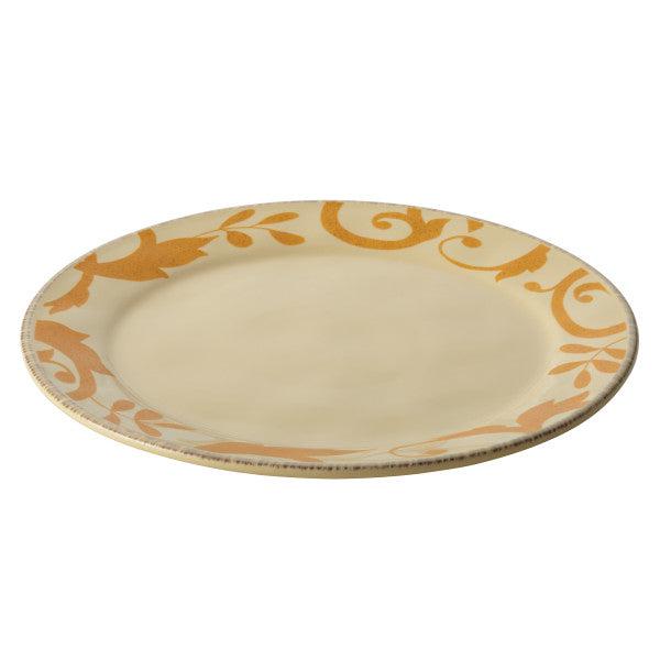 A beige plate with a golden floral pattern around the edge.