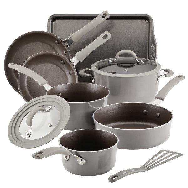 The Cook + Create Nonstick Cookware Sets include gray, nonstick pans, pots, lids, a baking tray, and a spatula that are scratch-resistant and oven safe.