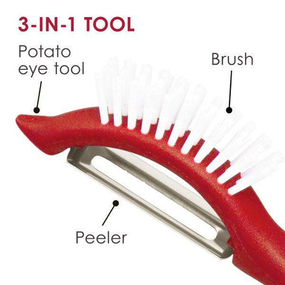 Close-up of a red 3-in-1 tool with a potato eye tool, brush, and peeler.