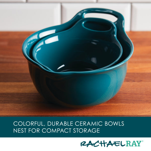 The 2-Piece Ceramic Mixing Bowl Set in a striking teal hue rests gracefully on a wooden countertop, creating a stunning contrast with the kitchen's tile backdrop. These multifunctional bowls are both stylish and dishwasher safe, offering convenience alongside their allure.