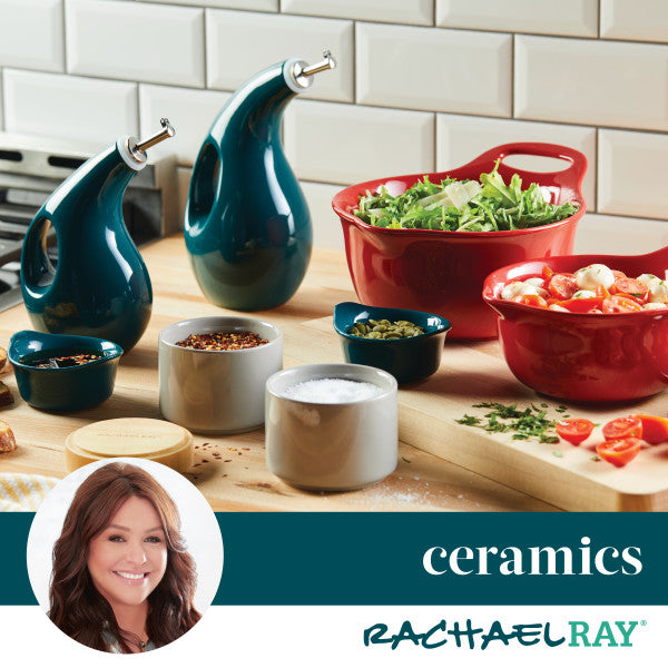 Kitchen counter with ceramic containers and dishes, herbs, and spices.