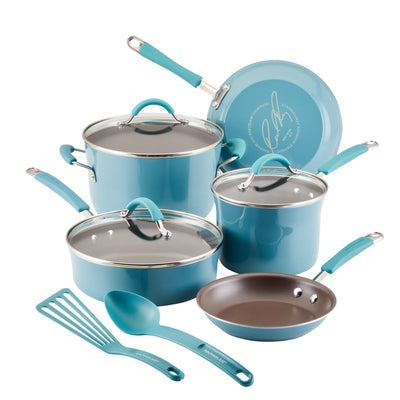 A teal cookware set with pots, pans, lids, spatula, and spoon.