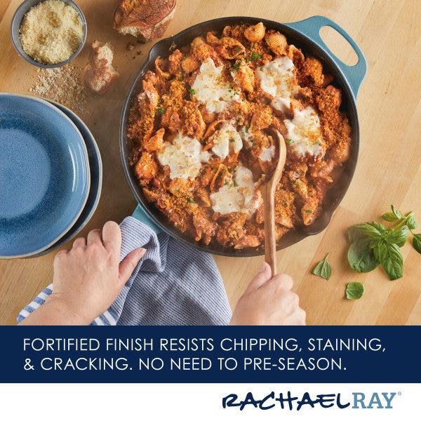 A pan of saucy pasta with melted cheese in a 12-Inch NITRO Cast Iron Skillet, accompanied by a wooden spoon on a table setting.