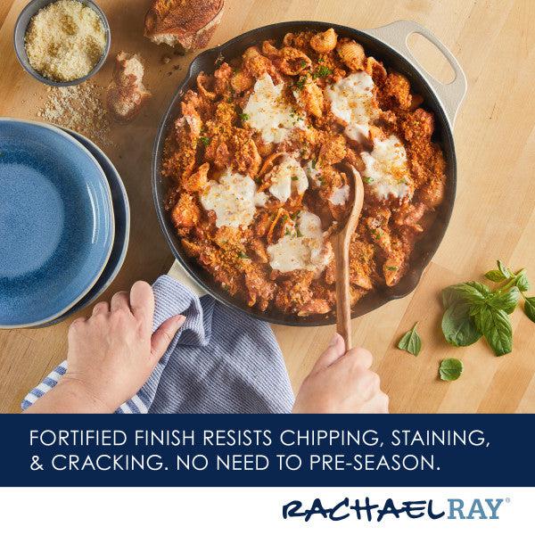 The 12-Inch NITRO Cast Iron Skillet, pre-seasoned for a delightful cooking experience, holds pasta in sauce and cheese, surrounded by blue plates and herbs.