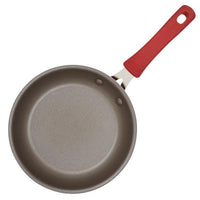 An overhead view of the Cook + Create Nonstick Frying Pan, featuring a red handle and crafted from thicker gauge aluminum for enhanced durability and nonstick performance.