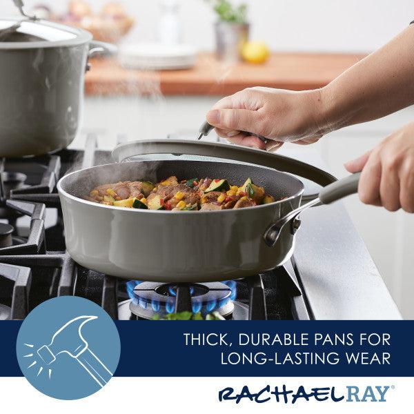Hands lifting the lid of a steaming 3-Quart Cook + Create Nonstick Sauté Pan on a gas stove, revealing its nonstick cooking surface.