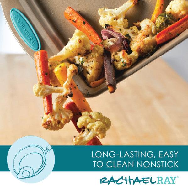 Roasted vegetables tumble from a Rachael Ray Cucina 2-Piece 9-Inch Nonstick Square Cake Pan with distinctive branding on the bottom.