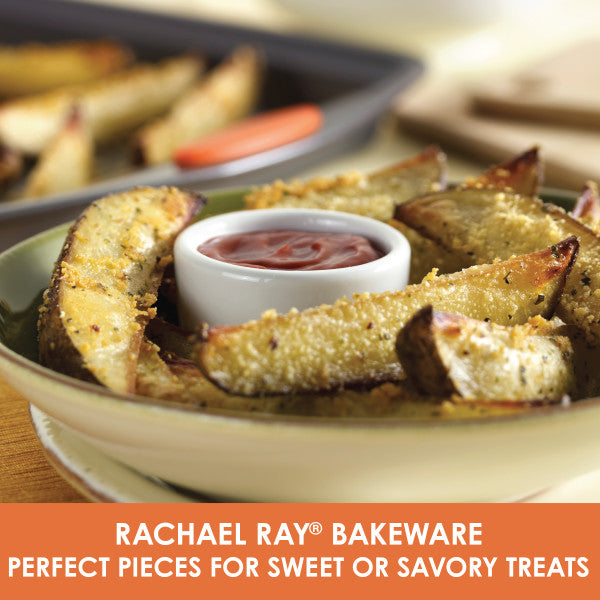 Potato wedges with dip on a plate next to a Rachael Ray 3-Piece Nonstick Sheet Pan Set, crafted from durable steel and conveniently oven safe.