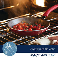Cherry tomatoes roasting in a vibrant red Cook + Create Nonstick Frying Pan, crafted from thicker gauge aluminum, inside an oven.