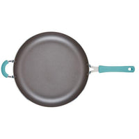 The Cook + Create Nonstick Frying Pan is designed with high-performance thicker gauge aluminum and features teal handles, set against a white background.