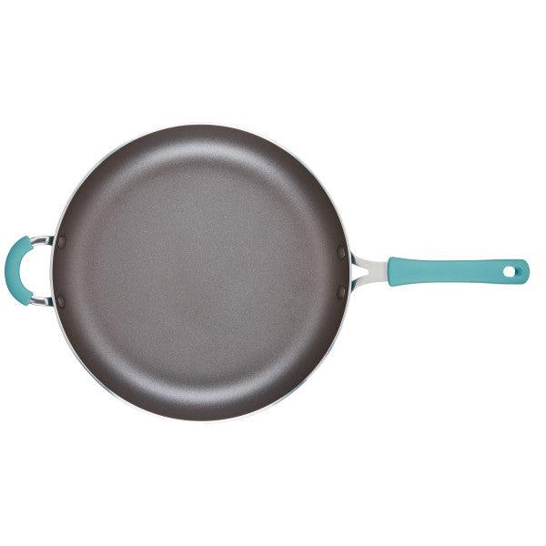 The Cook + Create Nonstick Frying Pan is designed with high-performance thicker gauge aluminum and features teal handles, set against a white background.