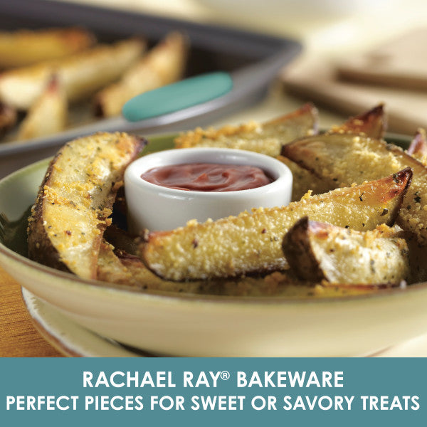 Potato wedges with dip elegantly displayed on a 3-Piece Nonstick Sheet Pan Set by Rachael Ray Bakeware, featuring durable steel that's oven safe for perfect results every time.