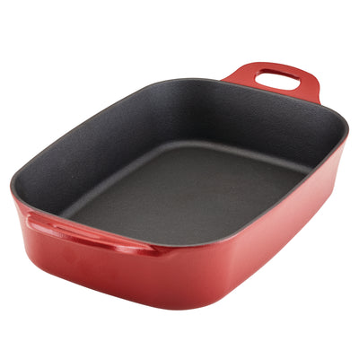 Red cast iron baking dish with handles on both sides.