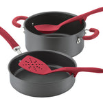 Nonstick pots and pans with red handles and matching red kitchen utensils.